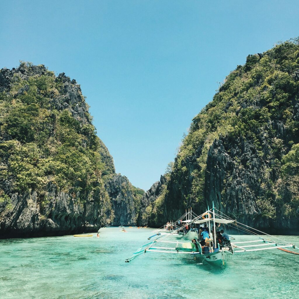 Explore El Nido's breathtaking lagoon with turquoise waters and lush cliffs, a perfect tropical getaway.