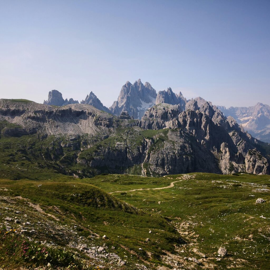 Spectacular mountain landscape in the Italian Dolomites with lush greenery and rugged peaks.